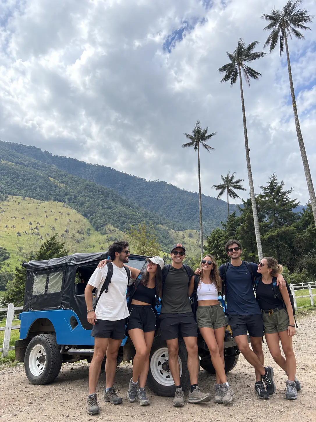 Seis amigos frente a un Willys azul, palmas de cera del valle de Cocora