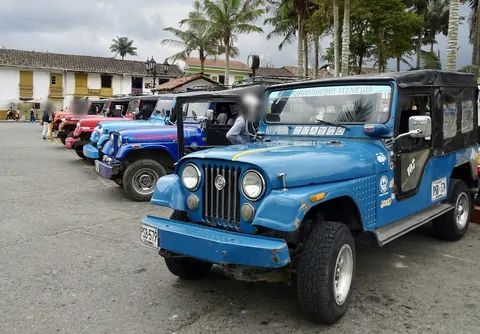 Jeep Willys lined up on a village square in Quindío
